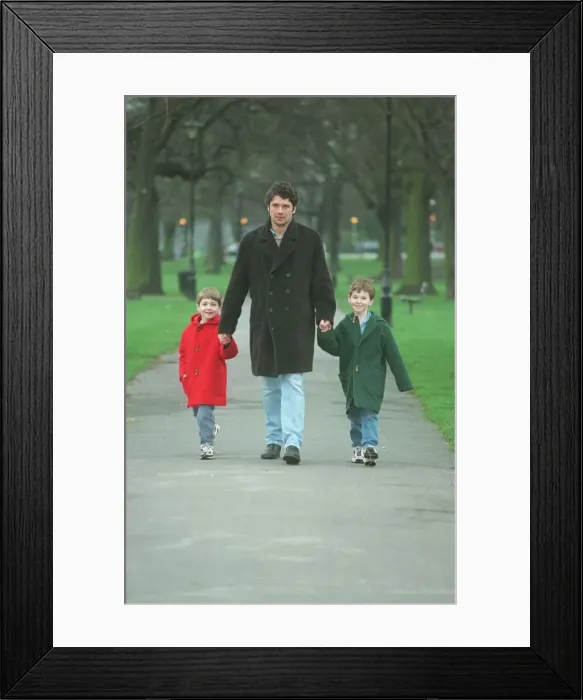 Framed Print : Dominic Taylor actor with his sons Arthur 6 in red coat Framed Print : Dominic Taylor actor with his sons Arthur 6 in red coat