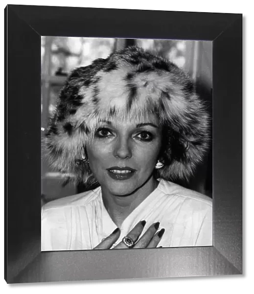 Joan Collins actress wearing a fur hat