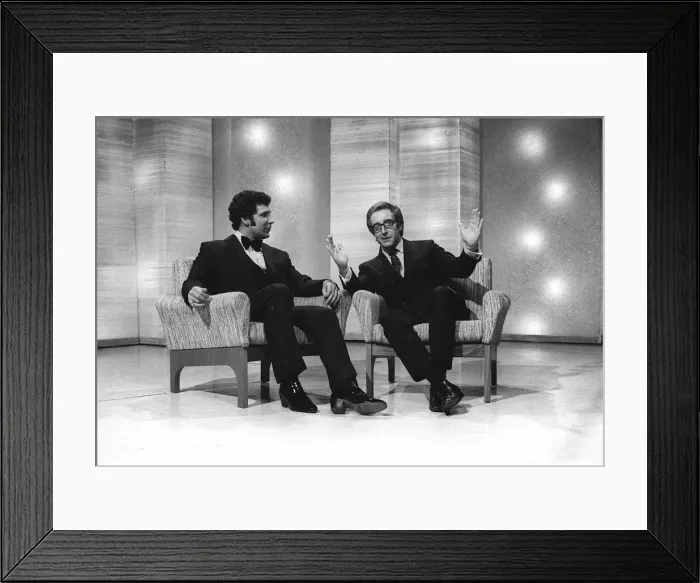 Framed Print : Singer Tom Jones with Actor Peter Sellers on a chat show - Sellers gestures with his Framed Print : Singer Tom Jones with Actor Peter Sellers on a chat show - Sellers gestures with his