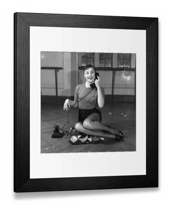 Framed Print : Actress Jean Marsh aged 17 posing sitting ona cushion and holding a phone