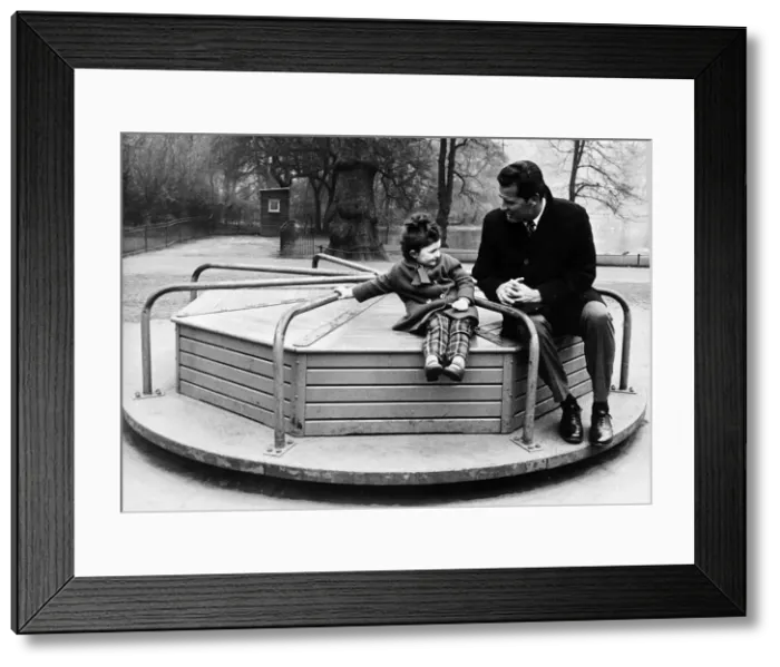 Framed Print : James Garner American actor on roundabout with child 1964 Framed Print : James Garner American actor on roundabout with child 1964