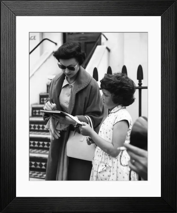 Framed Print : Actress Vivien Leigh signing autographs for a young fan in London August 1956 Framed Print : Actress Vivien Leigh signing autographs for a young fan in London August 1956
