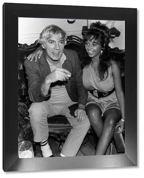 Peter Cook comedian actor and satarist, in July 1987 with topless model Maria Whittaker