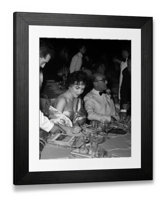Framed Print : Gina Lollobrigida signs an autograph for a waiter at the Venice Film Festival 1956