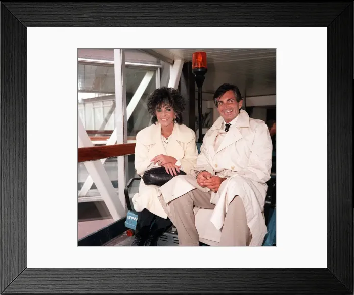 Framed Print : Liz Taylor actress and George Hamilton actor at London airport, August 1986