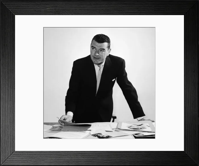 Framed Print : Actor Jack Hawkins looking at photographs on his desk April 1958