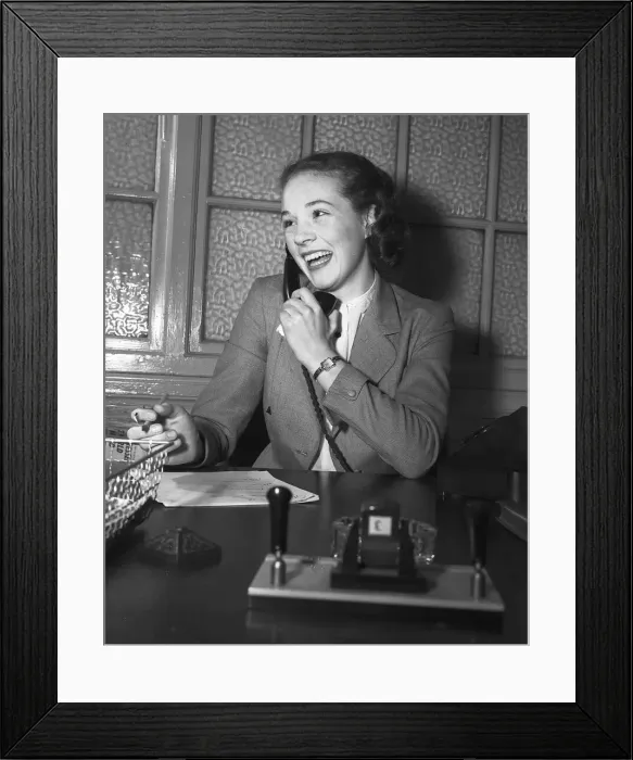 Framed Print : Actress Julie Andrews talking on the phone behind her desk January 1954 Framed Print : Actress Julie Andrews talking on the phone behind her desk January 1954