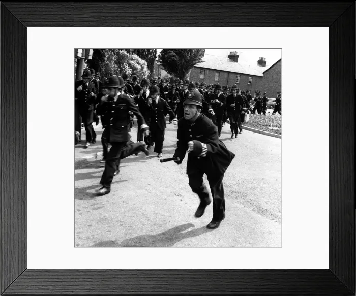 Framed Print : Norman Wisdom Comedian Actor in line with 120 policemen for the british comedy film Framed Print : Norman Wisdom Comedian Actor in line with 120 policemen for the british comedy film