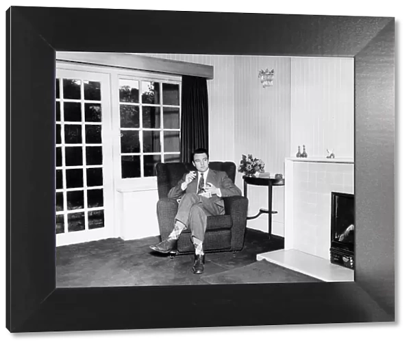 Donald Sinden film actor sitting in his chair at home smoking a cigarette 1959