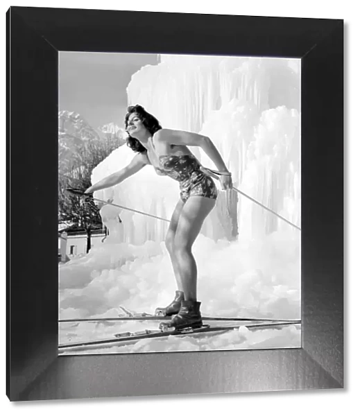 Winter Olympic Games 1956 Model in swimwear posing with skis on the ice -