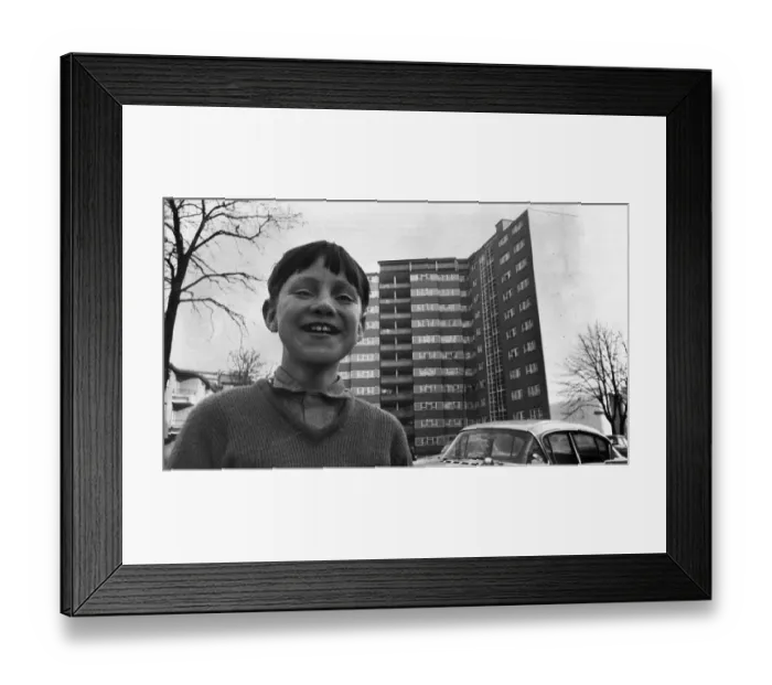 Framed Print : A small boy plays outside a block of flats in Stockwell South London Image used Framed Print : A small boy plays outside a block of flats in Stockwell South London Image used