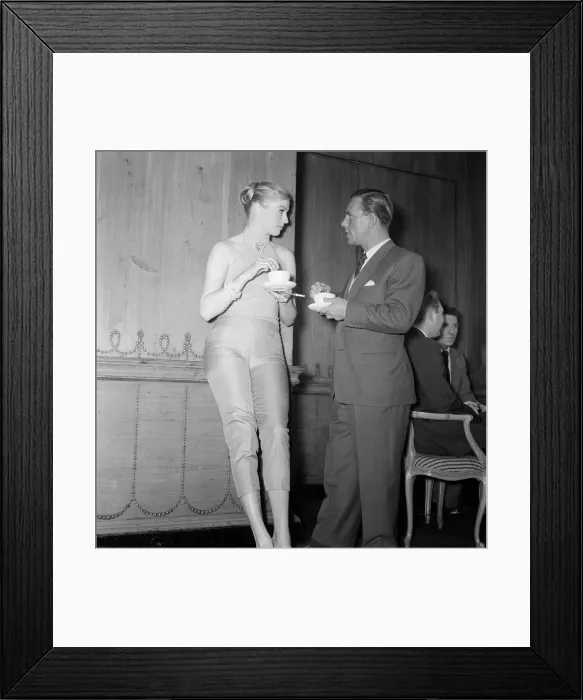 Framed Print : Actor and comedian Norman Wisdom enjoys a cup of tea with actress Anita Ekberg Framed Print : Actor and comedian Norman Wisdom enjoys a cup of tea with actress Anita Ekberg