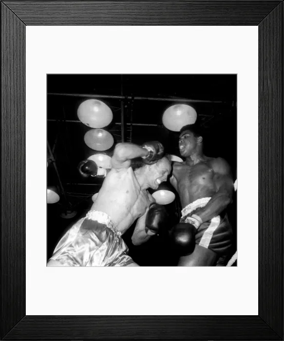 Framed Print : Action during the non-title heavyweight fight between American Cassius Clay