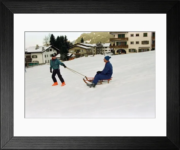 Framed Print : Prince Charles is pulled on a sledge by Prince Harry while on holiday in Klosters