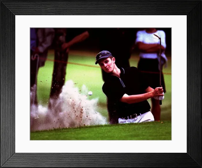 Framed Print : Justin Rose plays out of a greenside bunker on the 15th hole during the Dutch Open Golf