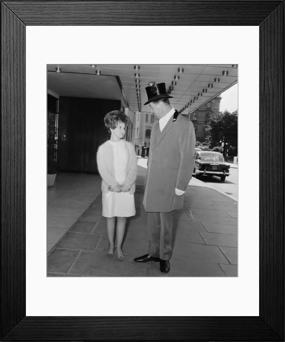 Framed Print : American pop singer Brenda Lee talking to one of the porters outside the Hilton Hotel in Framed Print : American pop singer Brenda Lee talking to one of the porters outside the Hilton Hotel in