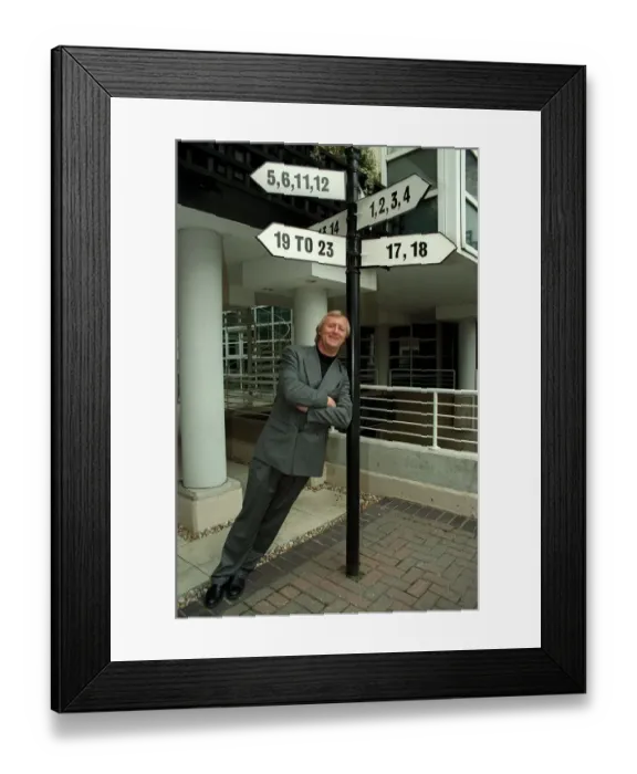 Framed Print : Chris Tarrant Radio / TV Presenter February 1997. Leaning on lamp post to promote Framed Print : Chris Tarrant Radio / TV Presenter February 1997. Leaning on lamp post to promote
