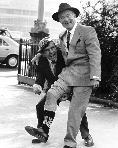 Ernie Wise with Noman Wisdom showing off his legs at the International Men