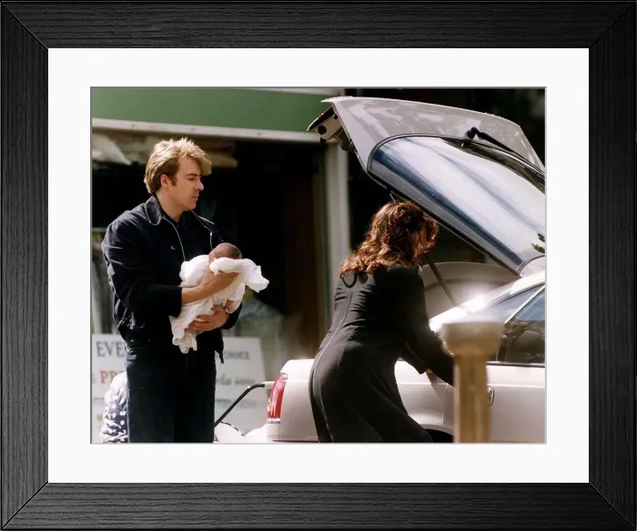 Framed Print : Jonathan Ross TV Presenter with wife Jane Ross holding new baby Framed Print : Jonathan Ross TV Presenter with wife Jane Ross holding new baby