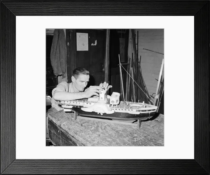 Framed Print : A blind model maker completes his latest model boat Circa 1957