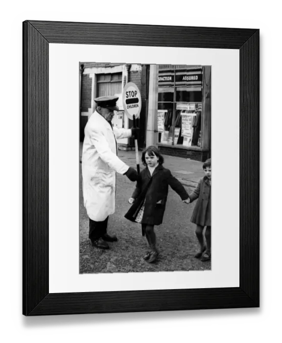 Framed Print : Road Safety - Lollipop Man  /  Woman - A Lollipop man safely crossing children on a busy