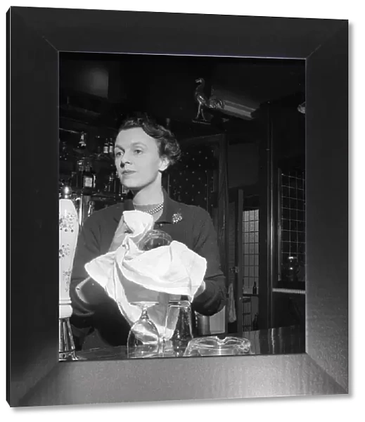 Mrs Hockey seen here working behind the bar of the Princess of Wales pub February 1957