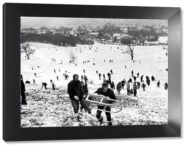 Children and adults playing in the snow on the Lickey Hills in Birmingham. 28  /  12  /  1970