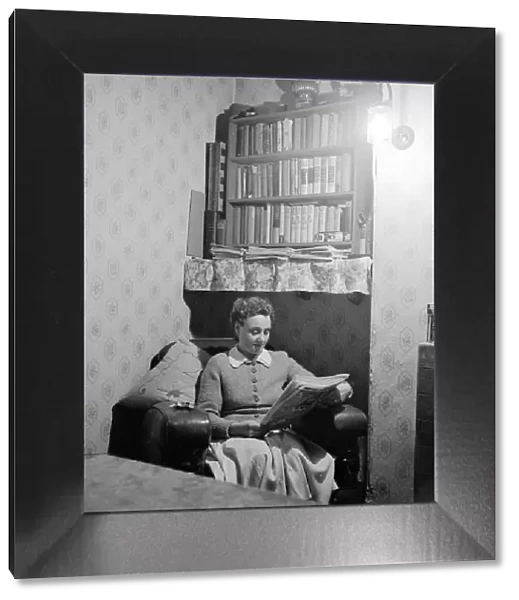 Mrs Dorothy Mead who still lights her house with gas lamps seen here reading her