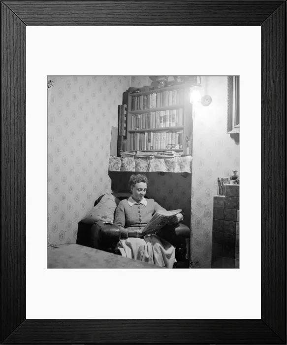Framed Print : Mrs Dorothy Mead who still lights her house with gas lamps seen here reading her