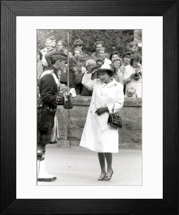 Framed Print : Queen Elizabeth II looking scared and gormless Holding hat on head Chatting Framed Print : Queen Elizabeth II looking scared and gormless Holding hat on head Chatting