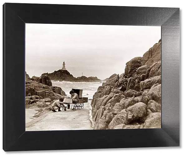 The two sons of the Corbiere Lighthouse keeper play on the causeway that leads to