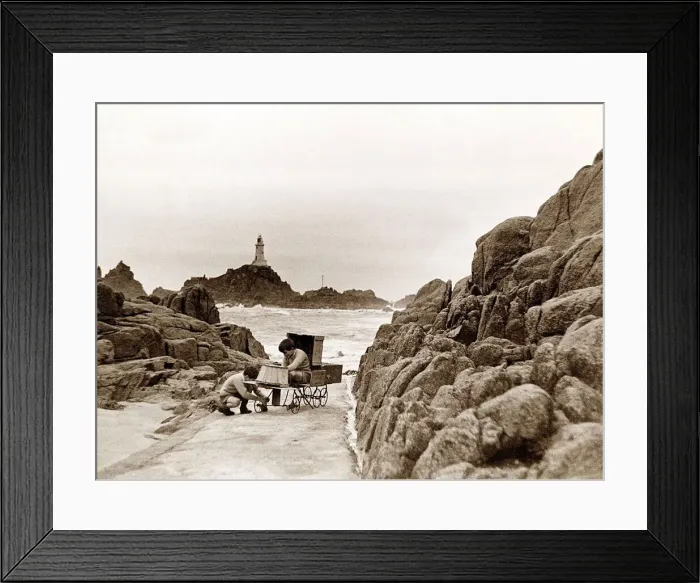 Framed Print : The two sons of the Corbiere Lighthouse keeper play on the causeway that leads to