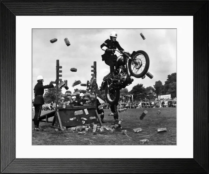 Framed Print : A rider of Royal Corps of Signals cycle display team crashes through a wall of bricks