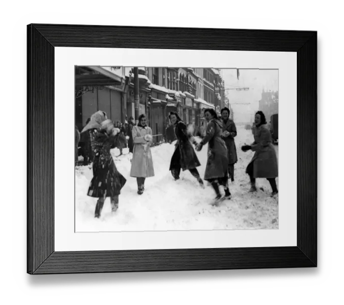 Framed Print : Weather - Some young shop girls enjoy snowballing during a heavy snowstorm in St Mary