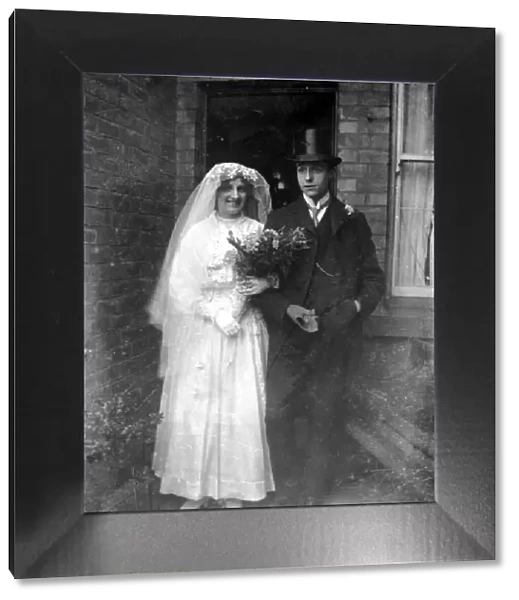 An old time wedding circa 1925 A bride and groom pose outside their North East home