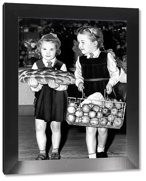 Harvest Festival. Two of the children arriving with harvest festival gifts at