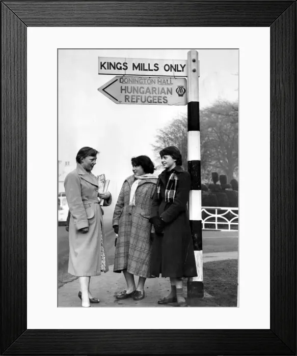 : Hungarian Refugees Three girl guides stand at the sign post for Hungarian Refugees : Hungarian Refugees Three girl guides stand at the sign post for Hungarian Refugees