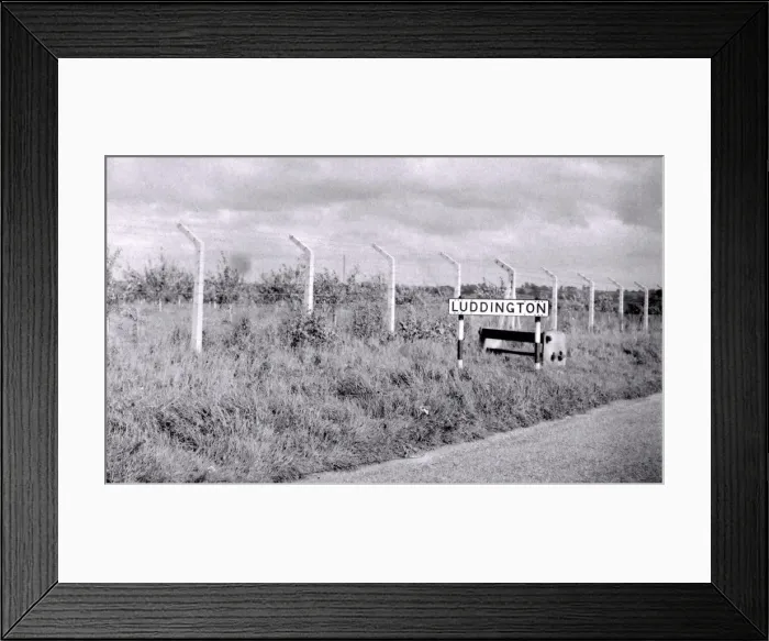 Framed Print : This seven foot-high barbered wire and steel mesh fence runs like a scar across one of