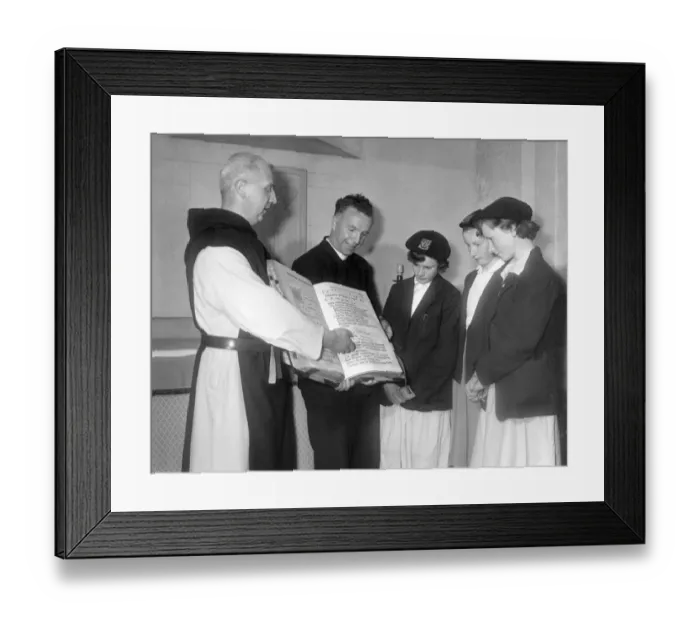 : Father Celsus shows some visitors one of the monastery books at Mount Saint Bernard in : Father Celsus shows some visitors one of the monastery books at Mount Saint Bernard in