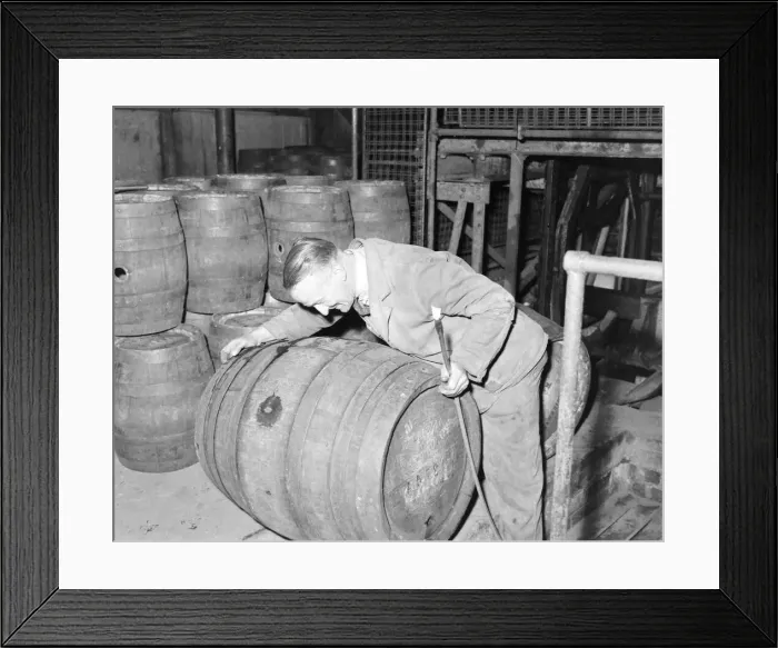 Framed Print : Workman rolling a barrel of ale at Ansells Brewery, September 1957 Framed Print : Workman rolling a barrel of ale at Ansells Brewery, September 1957