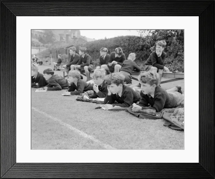  : Boys lying on the grass watching a game of cricket at St Chads Cathedral School