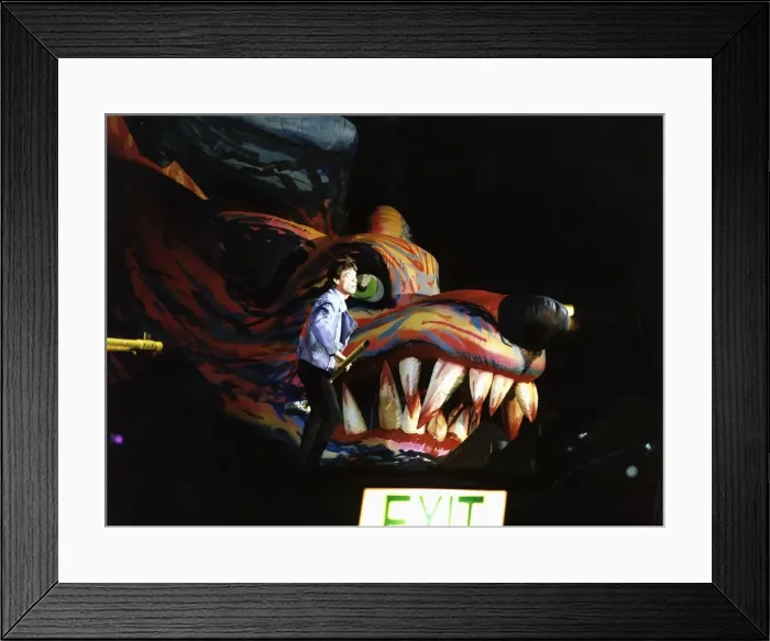 Framed Print : Rolling Stones: Mick Jagger on stage standing beside a Giant inflatable Dragons Head with Framed Print : Rolling Stones: Mick Jagger on stage standing beside a Giant inflatable Dragons Head with