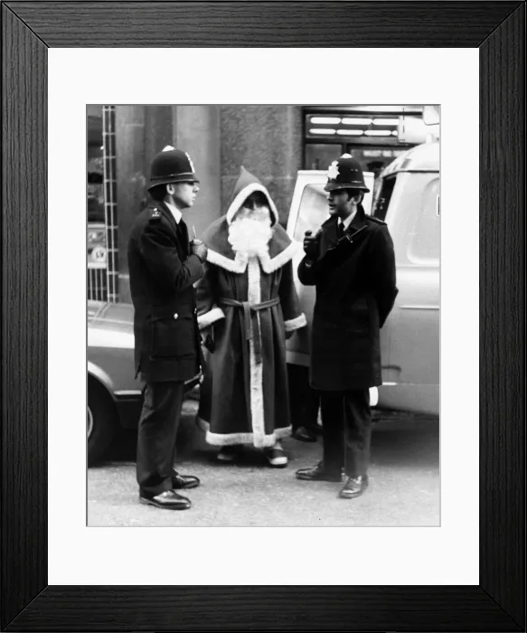 Framed Print : Policemen speak to Santa Claus outise Harrods Store in London after being nicked for Framed Print : Policemen speak to Santa Claus outise Harrods Store in London after being nicked for