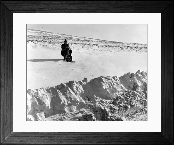 Framed Print : Under the sign Penalty for littering there is at least eight feet of hard snow