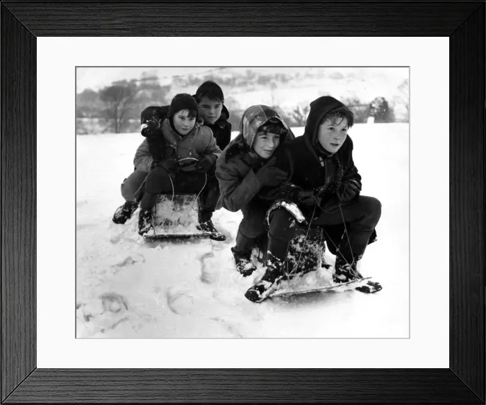 Framed Print : Children from Llantrisant go tobogganing - sledging on the slopes