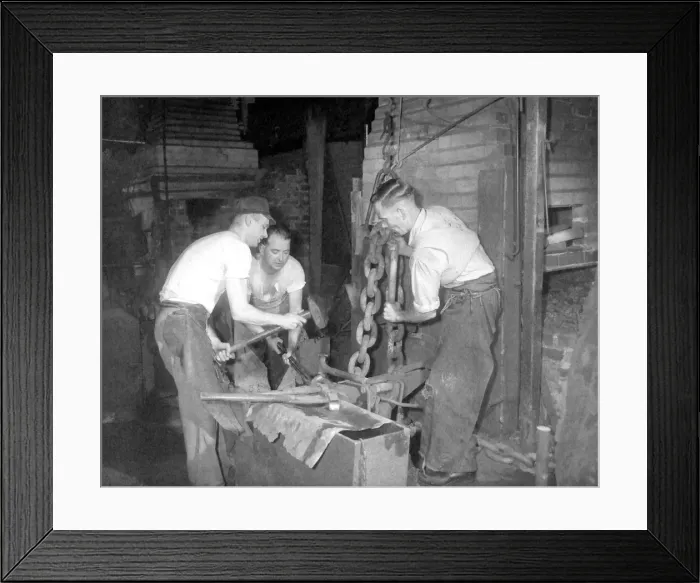 Framed Print : Chain-making is a hot, slogging job, but three who are used to the work are