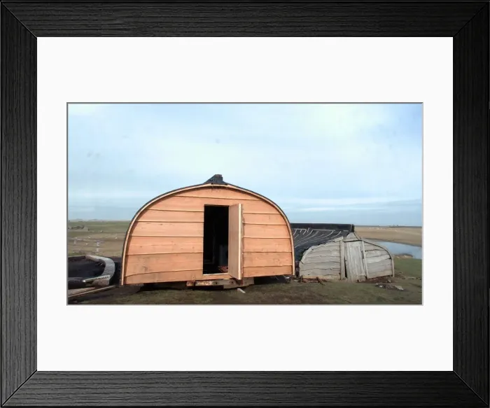 Framed Print : The upturned boats used as huts on Lindisfarne (Holy Island)