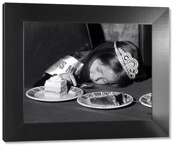 A young girl fall asleep on the table whilst eating a piece of cake - January 1980