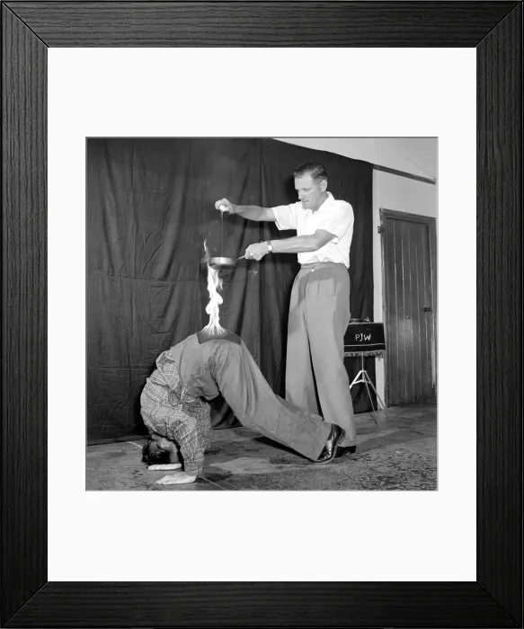Framed Print : In The Hot Seat Frank Batson fries an egg on the backside of Neville Wood to