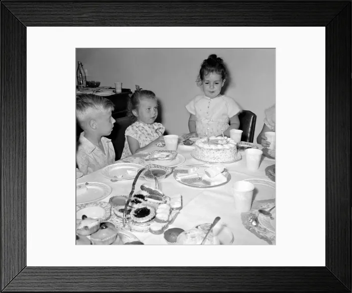 Framed Print : Eve Black celebrating her 4th Birthday Party with friends - Blowing out Framed Print : Eve Black celebrating her 4th Birthday Party with friends - Blowing out
